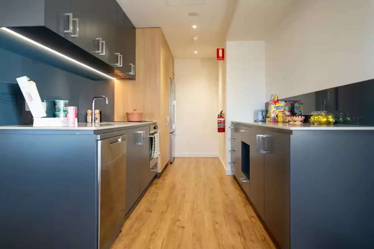 Modern grey cabinets sink and appliances kitchen at Scape Carlton in Melbourne Student Accommodation