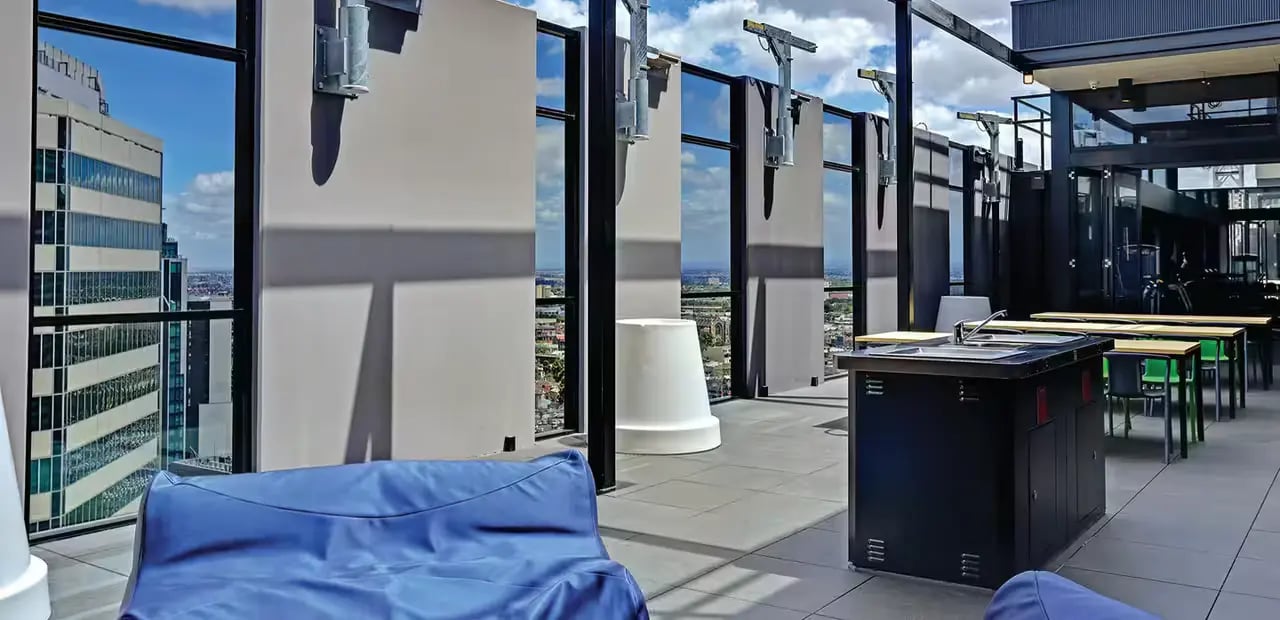 Blue beanbag outdoor sink tables chairs exterior at Scape Melbourne Central in Melbourne Student Accommodation