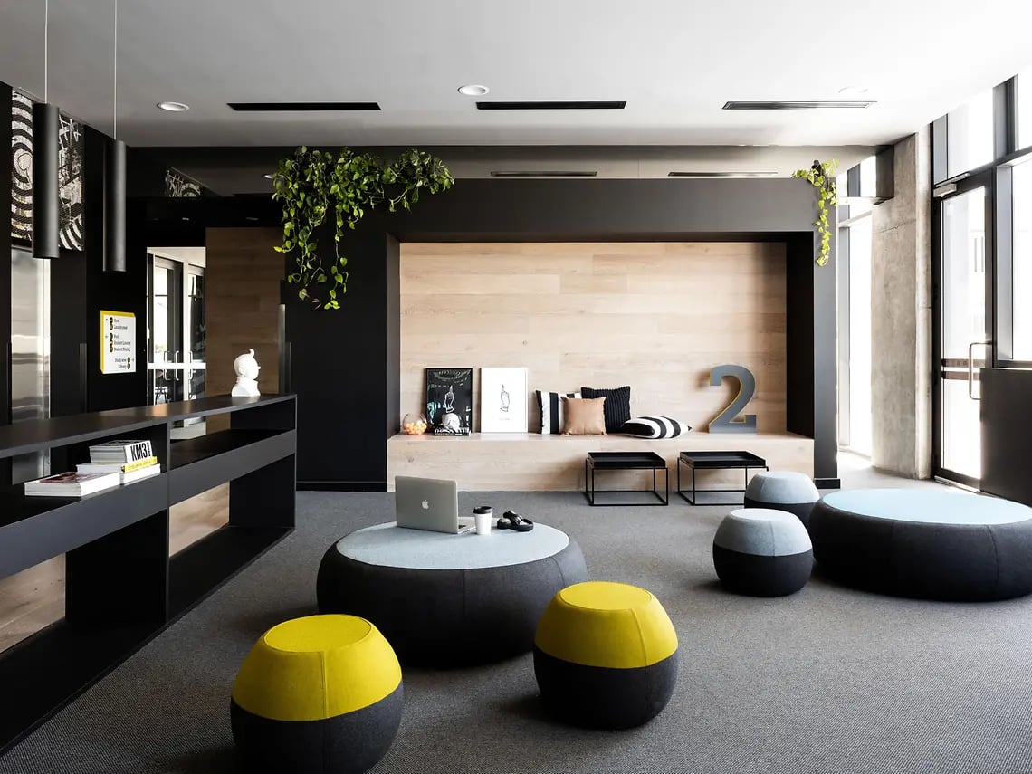 Modern lobby with plush seating and wood accent wall living room at Yugo Perth City in Perth Student Accommodation