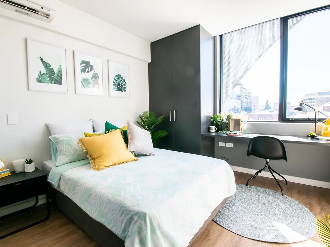 Bed desk artwork and plant bedroom at Yugo Perth City in Perth Student Accommodation