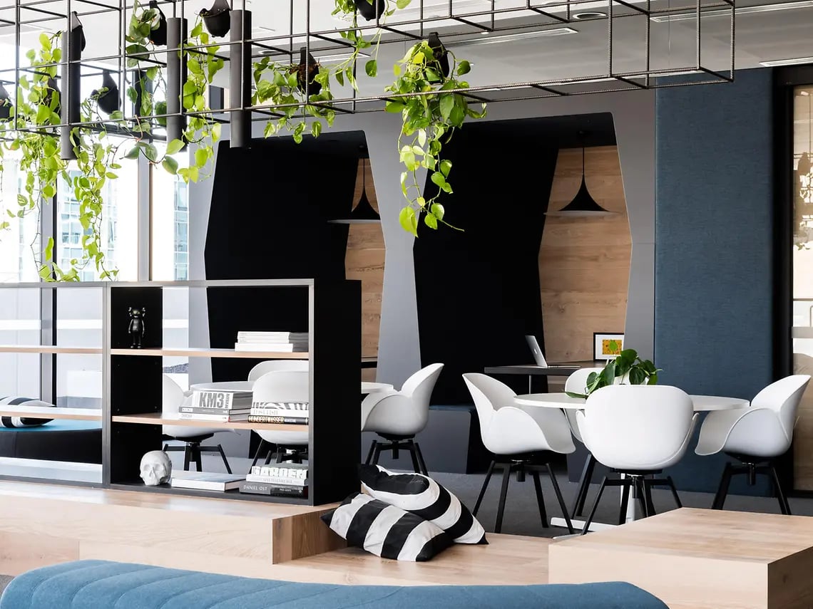 White chairs round table black shelves living room at Yugo Perth City in Perth Student Accommodation