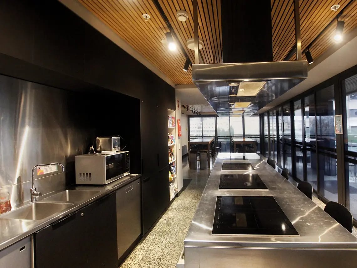 Microwave sink toaster and cooking stovetop kitchen at Yugo University Square Melbourne in Melbourne Student Accommodation