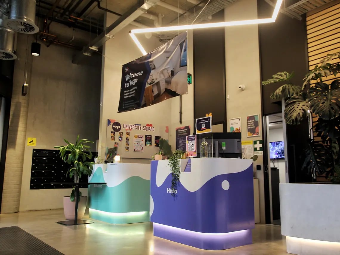 Welcome desks plants and lockers reception area at Yugo University Square Melbourne in Melbourne Student Accommodation