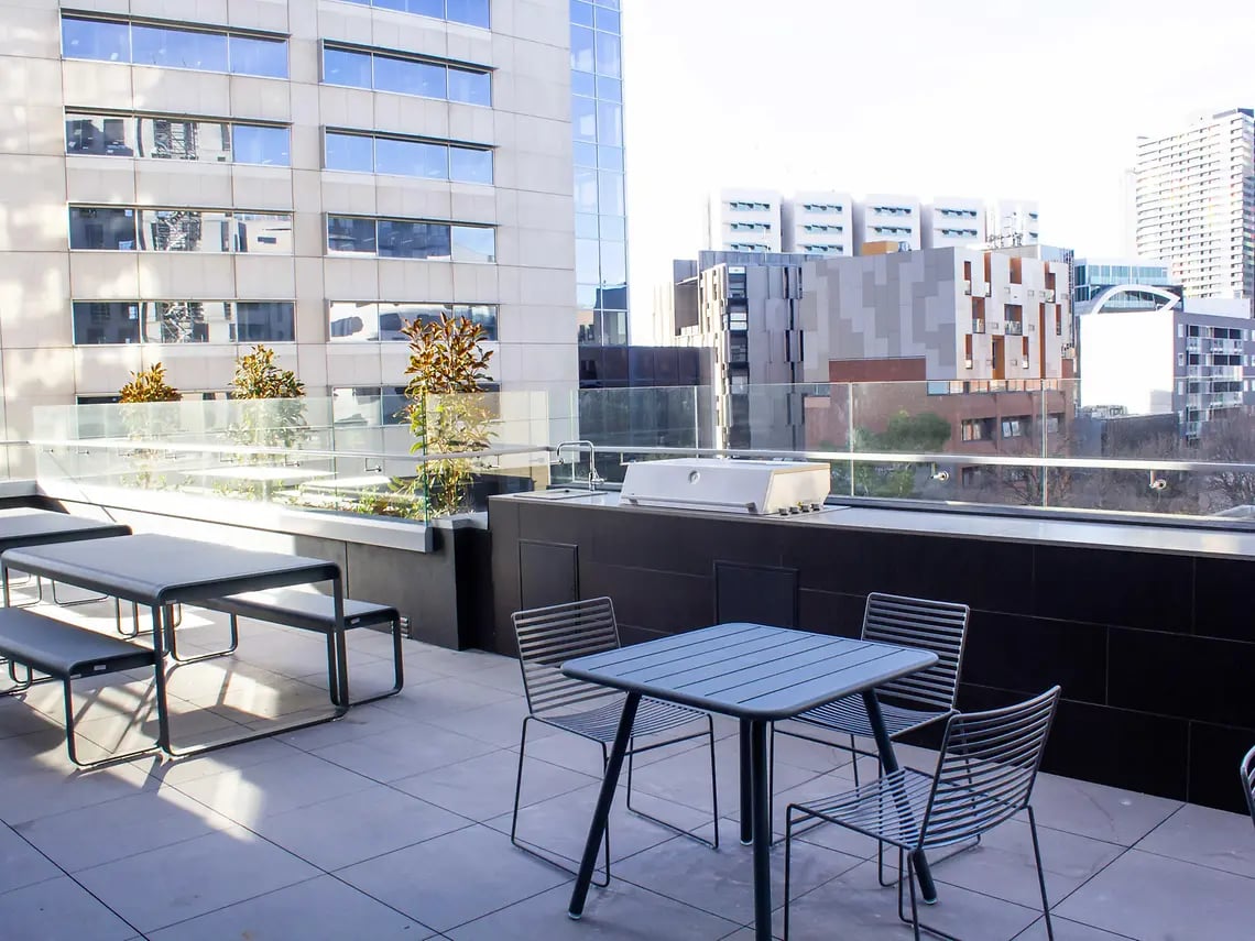 Outdoor patio tables grill sink balcony area at Yugo University Square Melbourne in Melbourne Student Accommodation