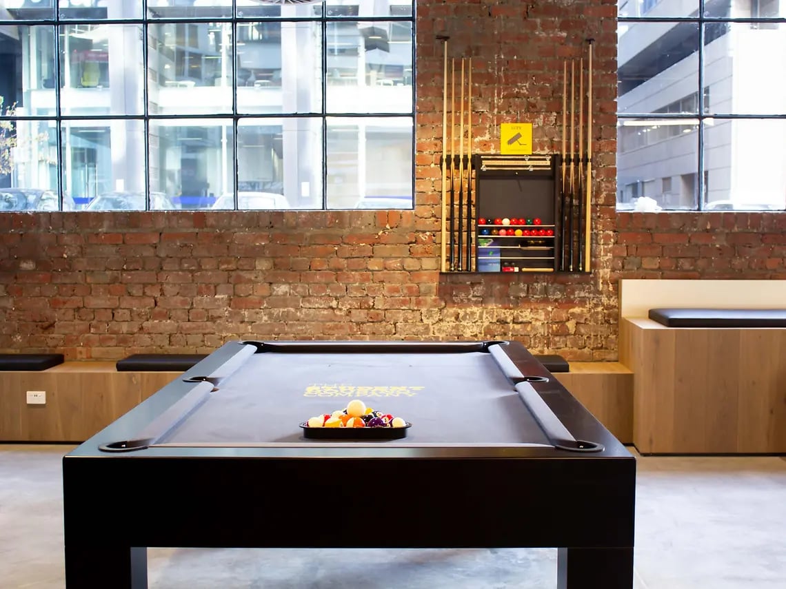 Pool table with balls billiards cue rack lounge area at Yugo University Square Melbourne in Melbourne Student Accommodation