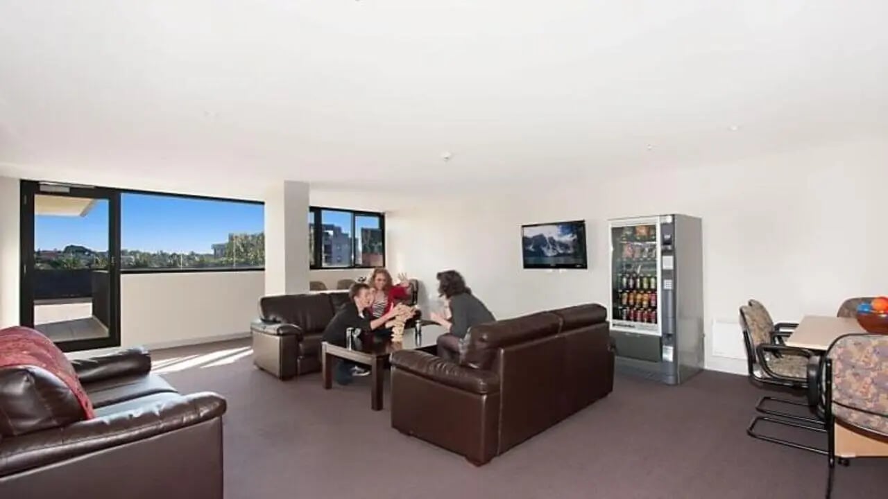 Leather couches vending machine TV common room at Student Living - Vivida in Melbourne Student Accommodation