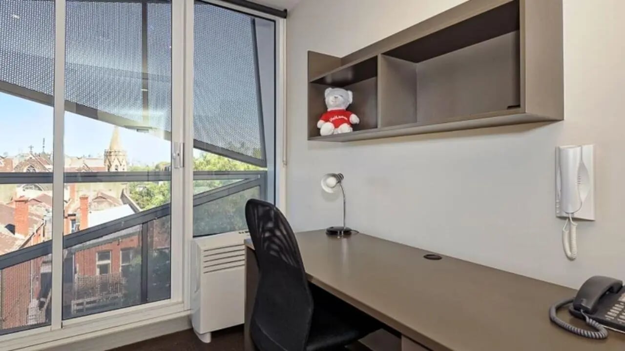 Desk chair shelving unit with bear and window study area at Student Living - Vivida in Melbourne Student Accommodation