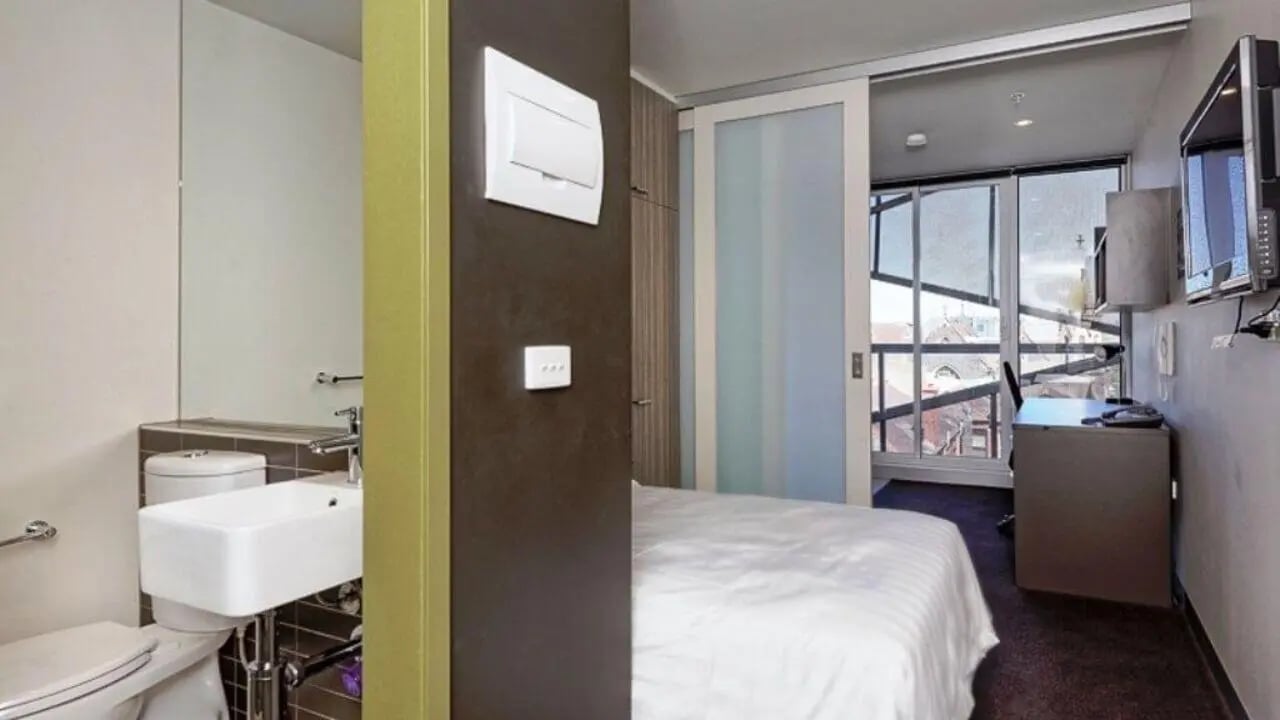 Toilet sink bed desk TV bedroom at Student Living - Vivida in Melbourne Student Accommodation