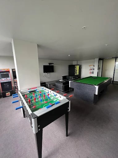 Foosball table billiard table arcade games lounge at Student Living - Vivida in Melbourne Student Accommodation