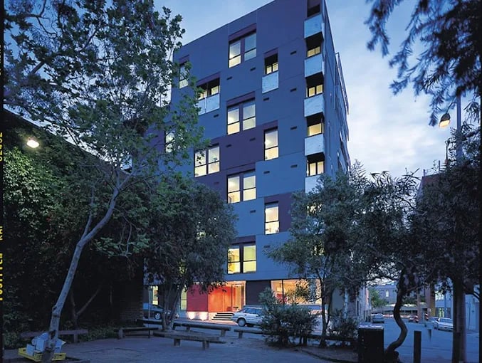 Modern building with trees and benches exterior at Student Living On Campus in Melbourne Student Accommodation