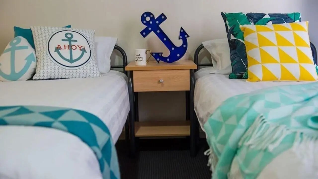 Beds with nautical pillows and throws Bedroom at Student Living on Flinders in Melbourne Student Accommodation