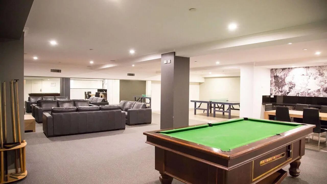 Pool table ping pong tables leather sofas communal lounge at Student Living on Flinders in Melbourne Student Accommodation