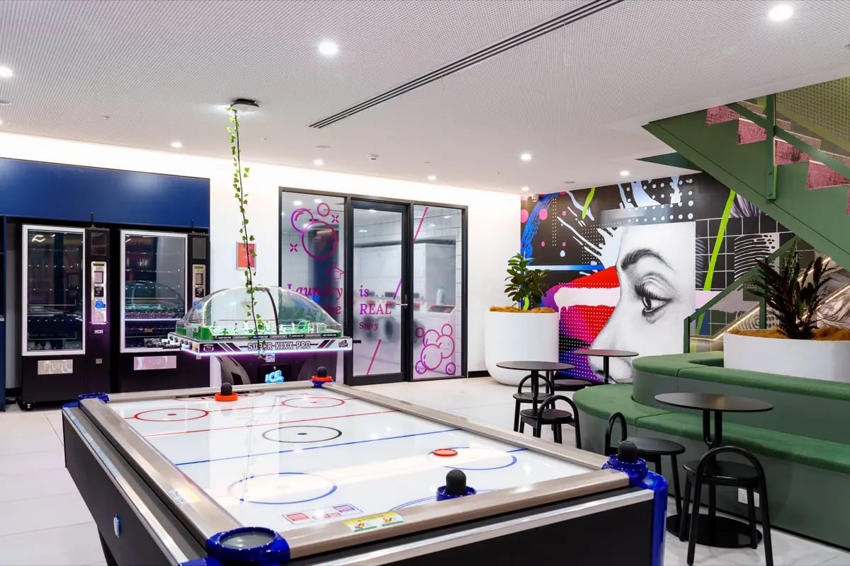 Air hockey table vending machines laundry room playing area at The Switch Melbourne Victoria Market in Melbourne Student Accommodation