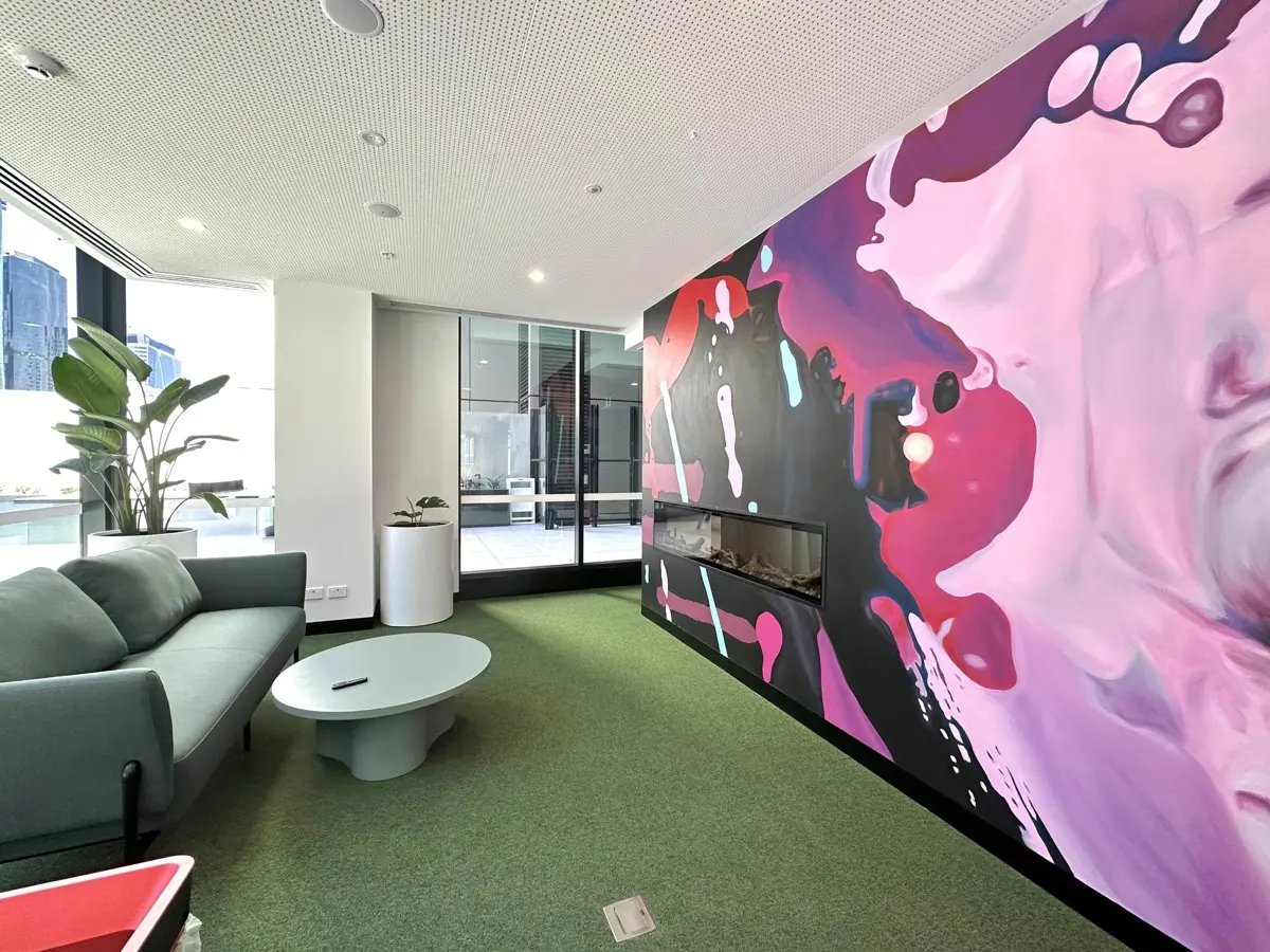 Sofa coffee table mural fireplace lounge area at The Switch Melbourne Victoria Market in Melbourne Student Accommodation