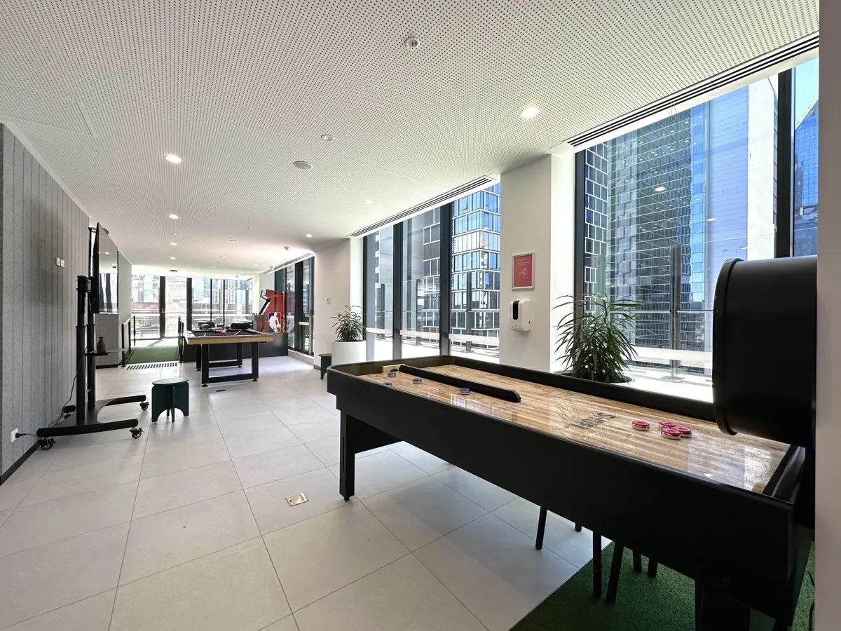Shuffleboard table gaming tables large windows lounge area at The Switch Melbourne Victoria Market in Melbourne Student Accommodation