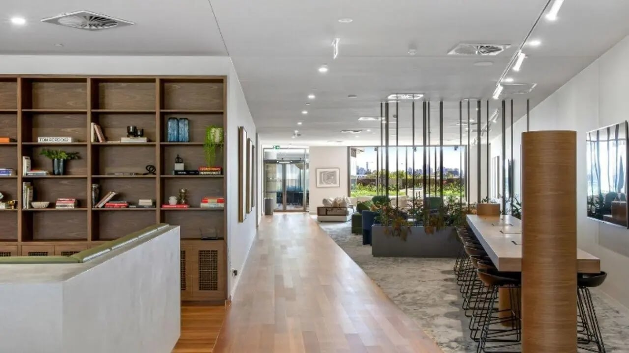 Bookshelves communal table lounge area living room at Realm Caulfield in Melbourne Student Accommodation