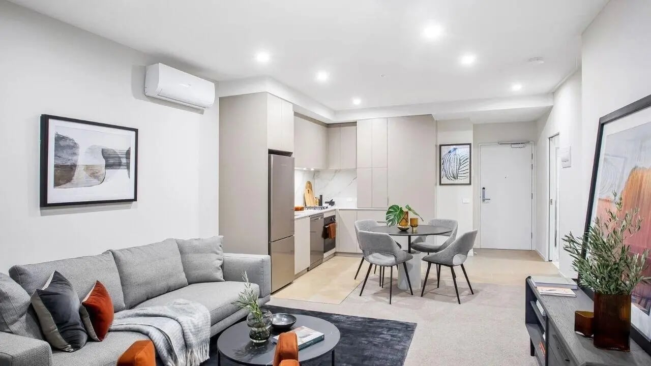 Sofa kitchen table and chairs living room at Realm Caulfield in Melbourne Student Accommodation