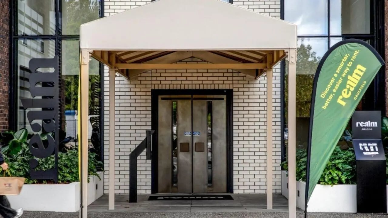 Double doors under awning with signage exterior at Realm Caulfield in Melbourne Student Accommodation
