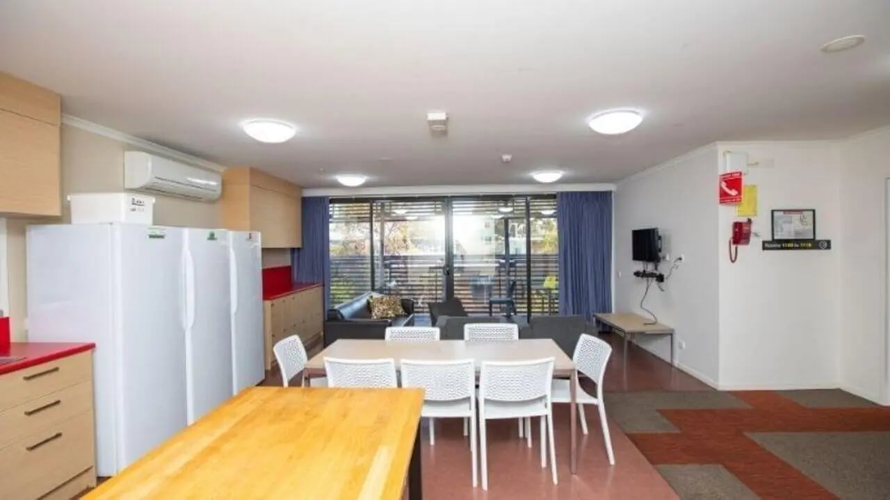 White refrigerators dining table and lounge living room at La Trobe University - Hillside Apartments in Melbourne Student Accommodation