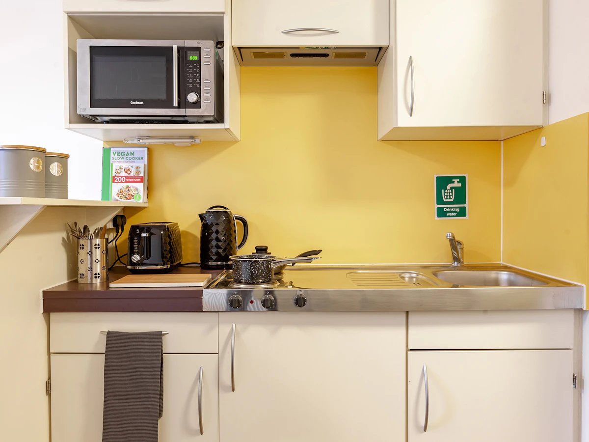 Microwave toaster kettle sink and stove kitchen at Fulham Palace Studios in London Student Accommodation
