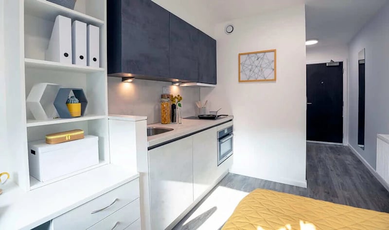 White shelves modern kitchen and hallway exterior at Westcombe House in London Student Accommodation