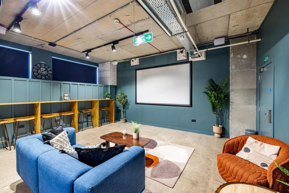Blue sofa coffee table rug then living room at Chapter Portobello in London Student Accommodation