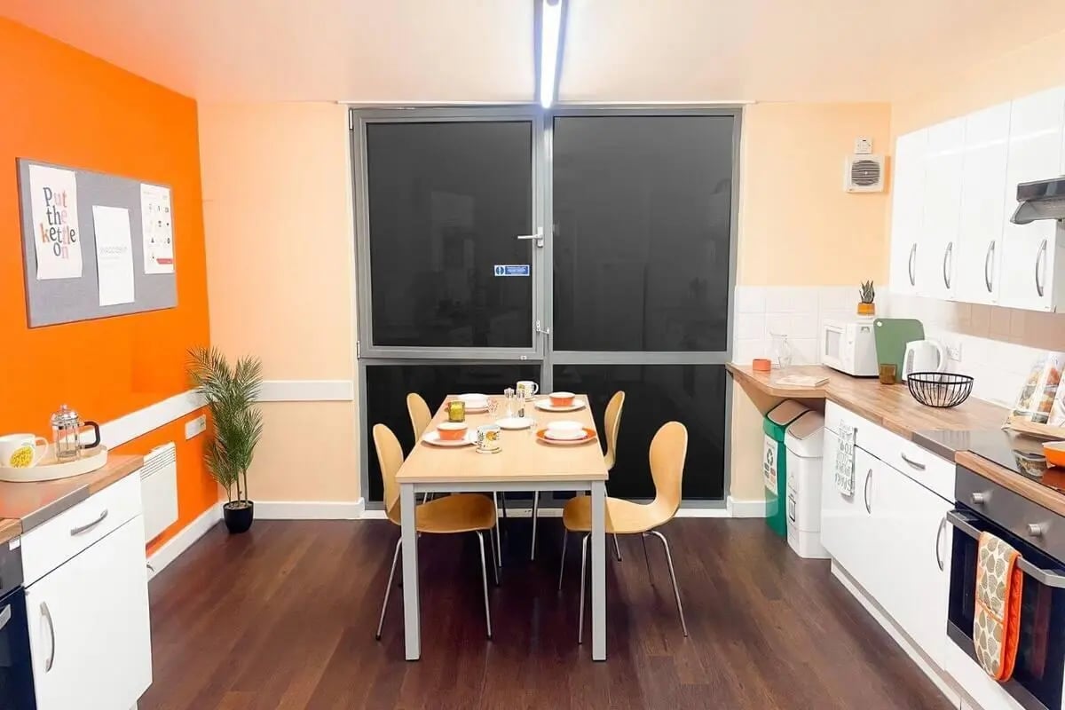 Dining table with chairs and kitchen counter kitchen at Don Gratton House in London Student Accommodation