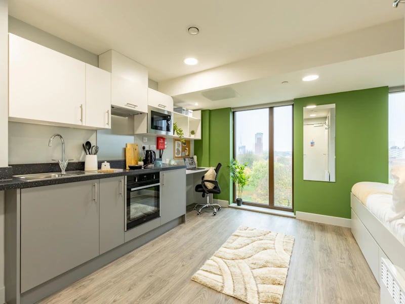 Kitchen with sink oven and bed Studio at Venue Studios in London Student Accommodation