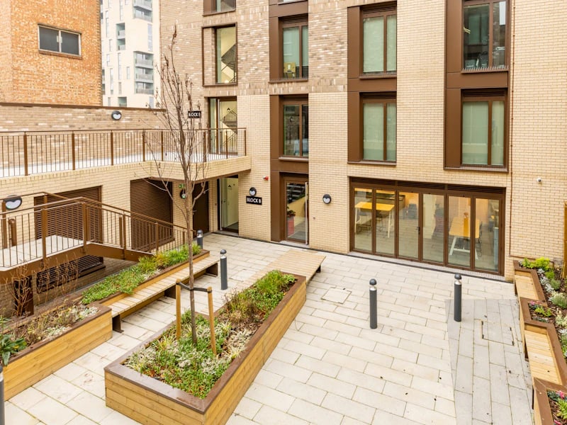 Courtyard with plants and seating exterior at Venue Studios in London Student Accommodation