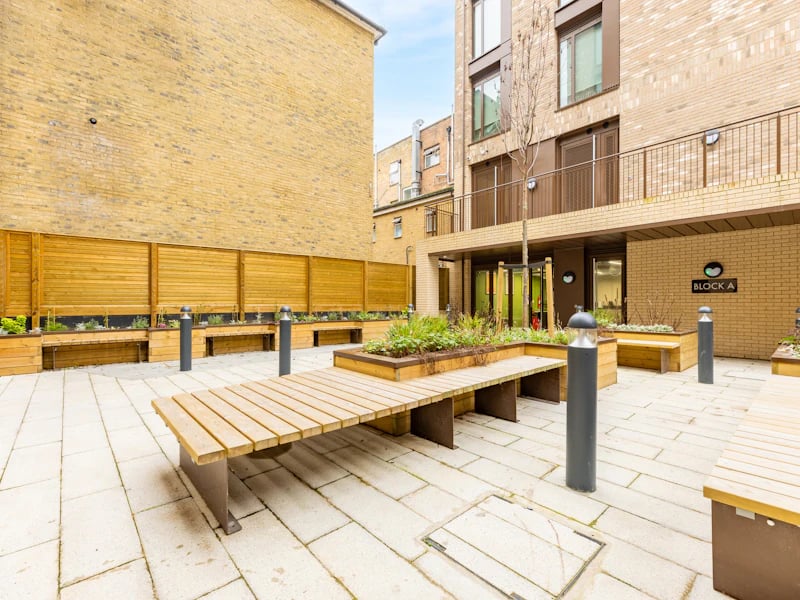 Wooden benches planters lights Block A exterior at Venue Studios in London Student Accommodation