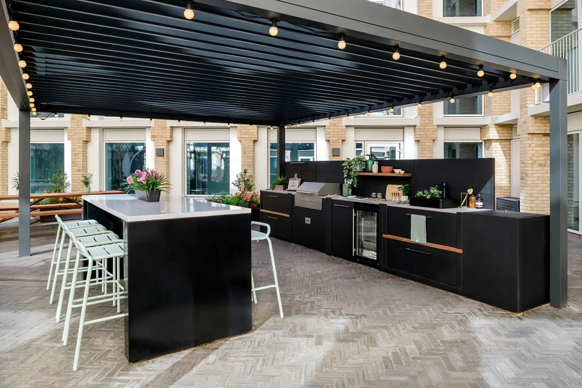Outdoor kitchen with bar and grill patio area at Wick Park in London Student Accommodation