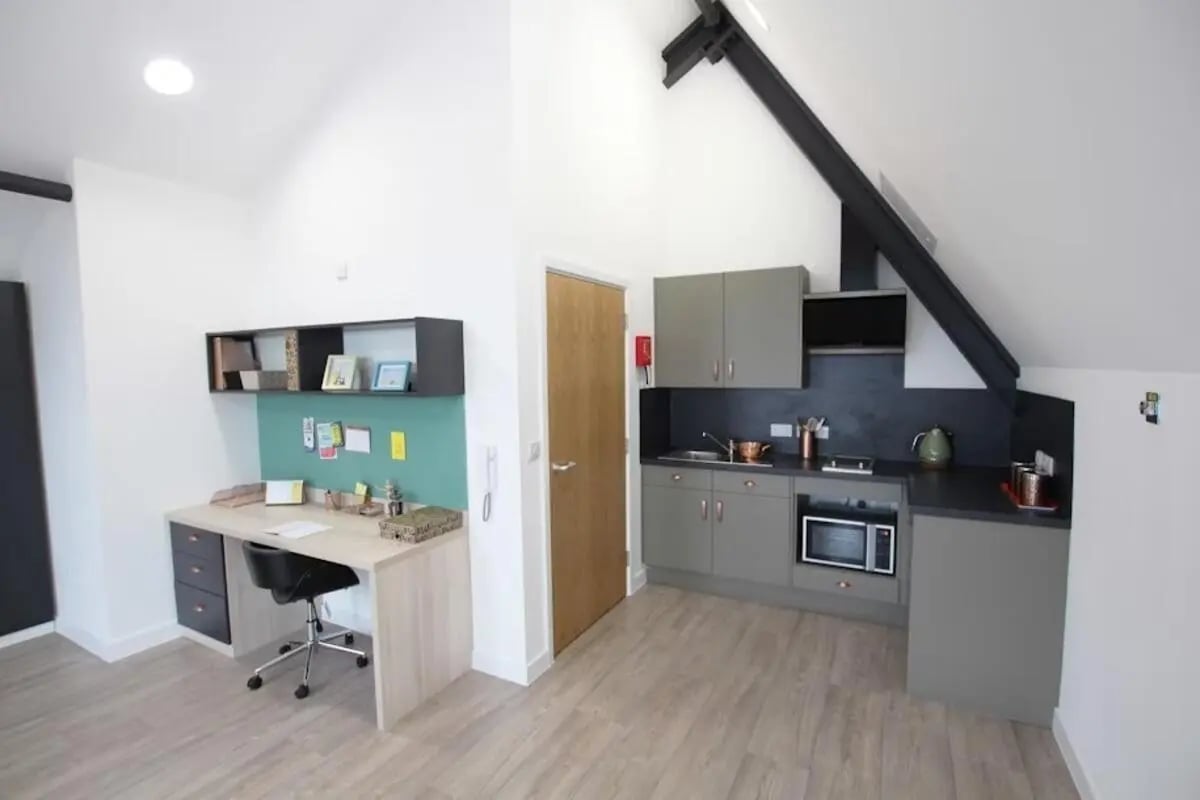 Desk chair shelves microwave kitchenette Kitchen at Mannequin House in London Student Accommodation