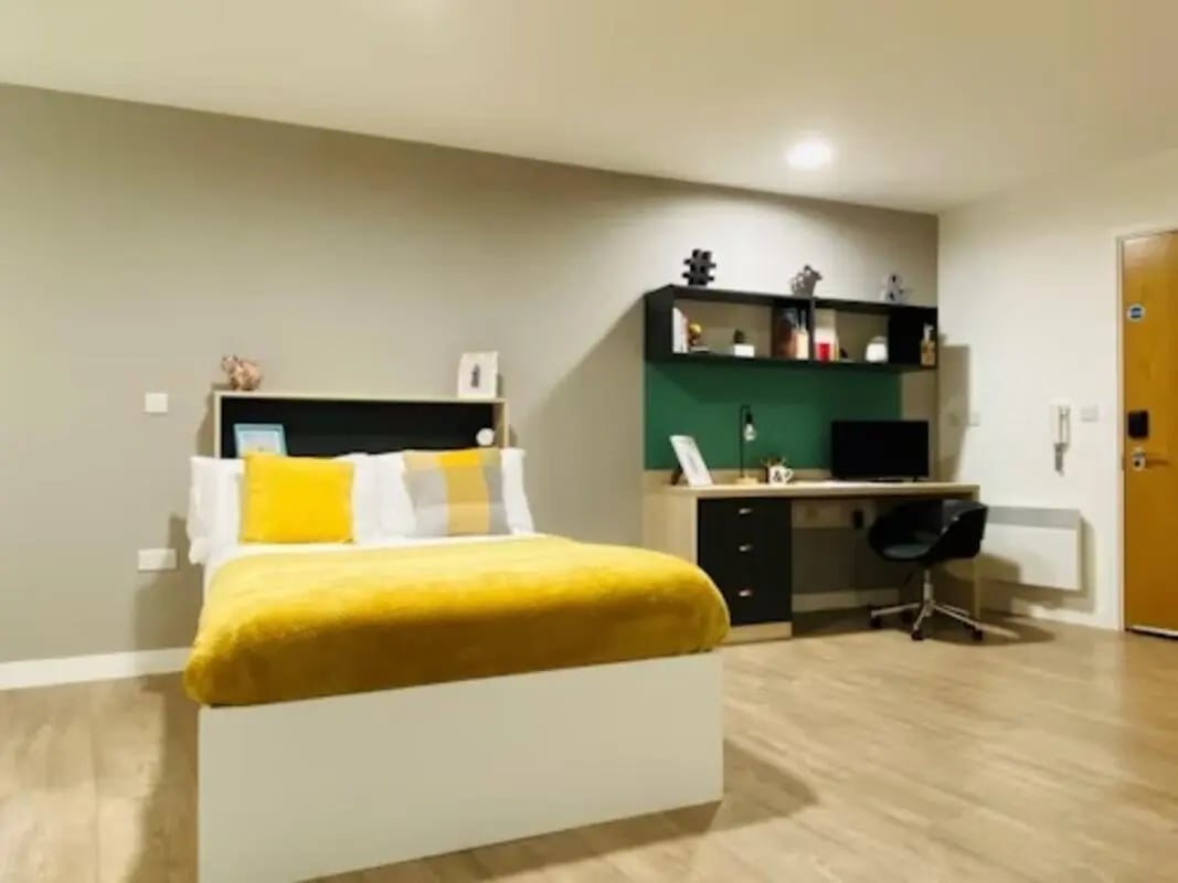 Bed desk chair shelves and door bedroom study area at Mannequin House in London Student Accommodation