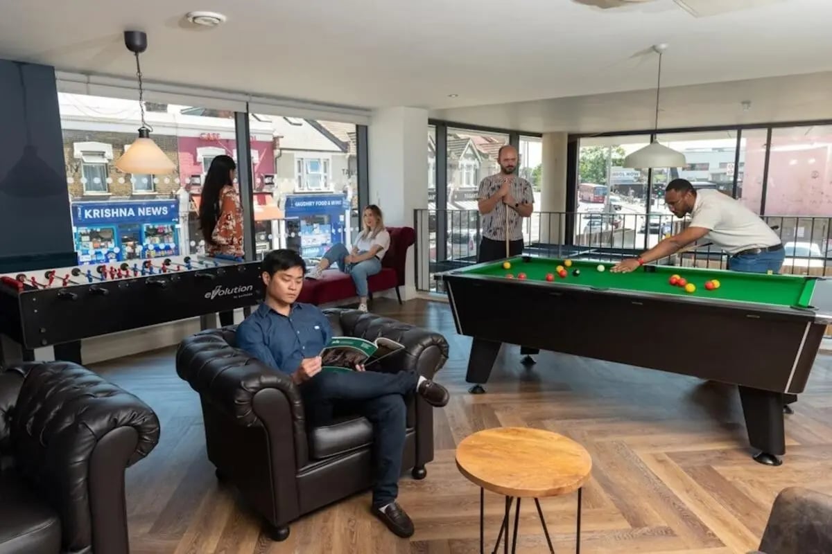 Foosball table pool table men reading lounge area at Mannequin House in London Student Accommodation