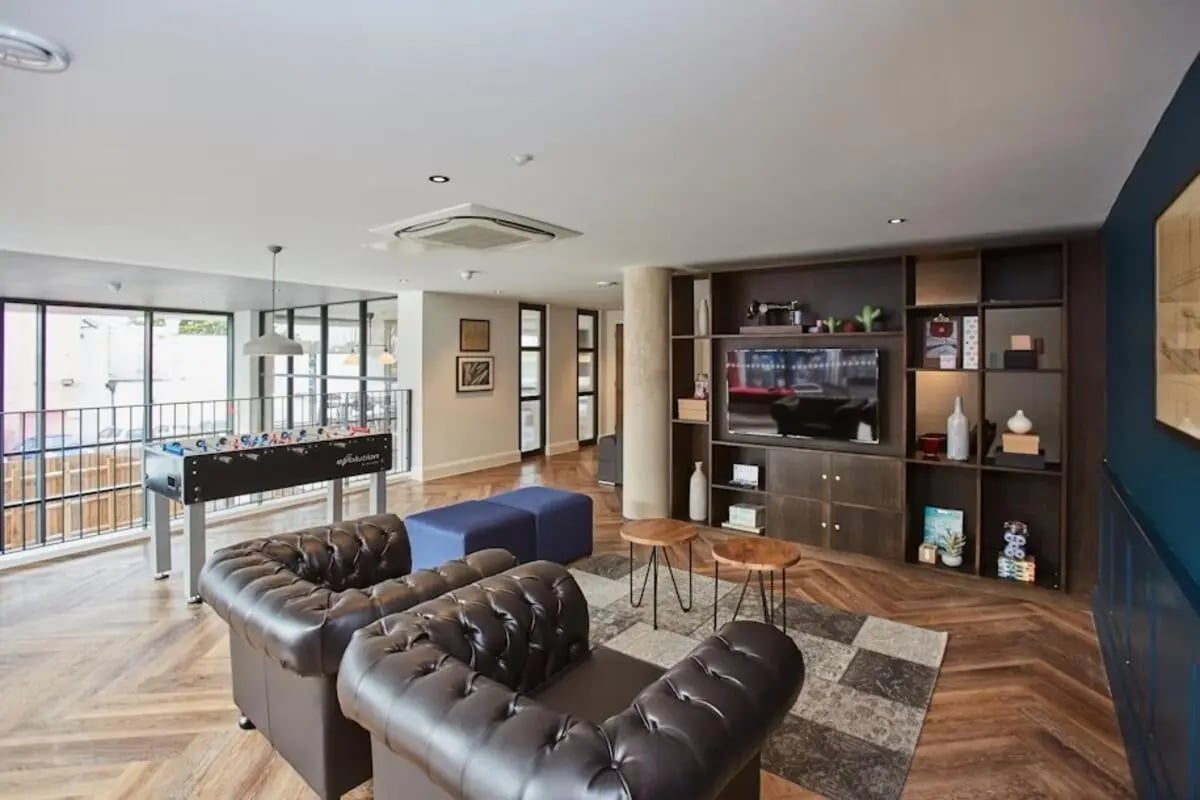 Leather sofas foosball table entertainment unit living room at Mannequin House in London Student Accommodation