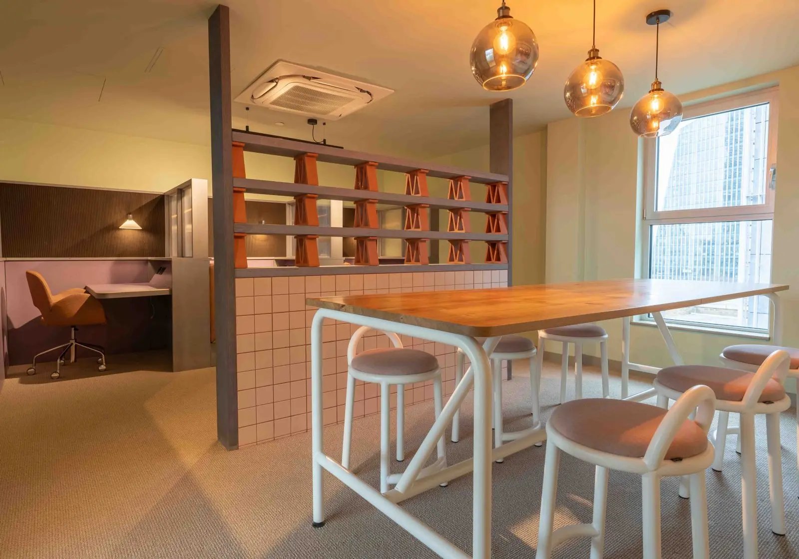 Table with stools study area and partition study at iQ Paris Gardens in London Student Accommodation