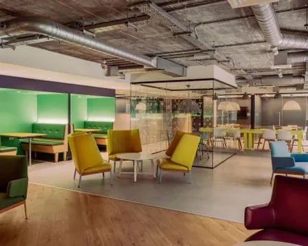 Colorful lounge area with booths and meeting rooms lounge area at Scape Wembley in London Student Accommodation