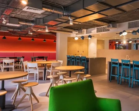 Modern communal dining tables seating kitchen living room at Scape Wembley in London Student Accommodation