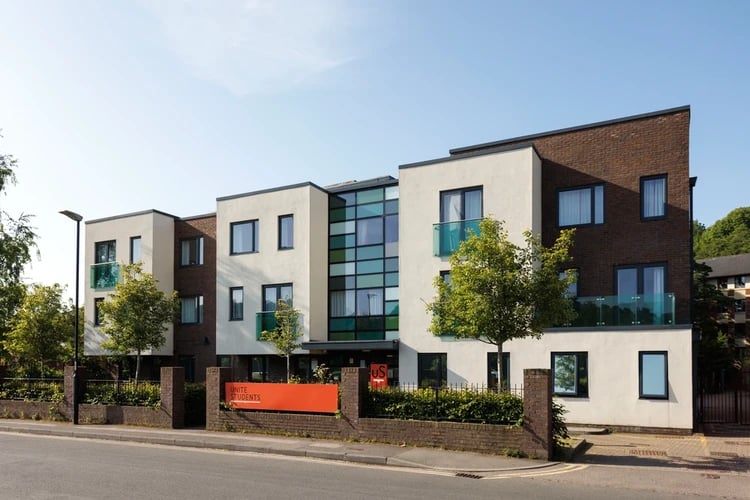 Modern student accommodation building with orange signage exterior at Elvet Studios in Durham Student Accommodation