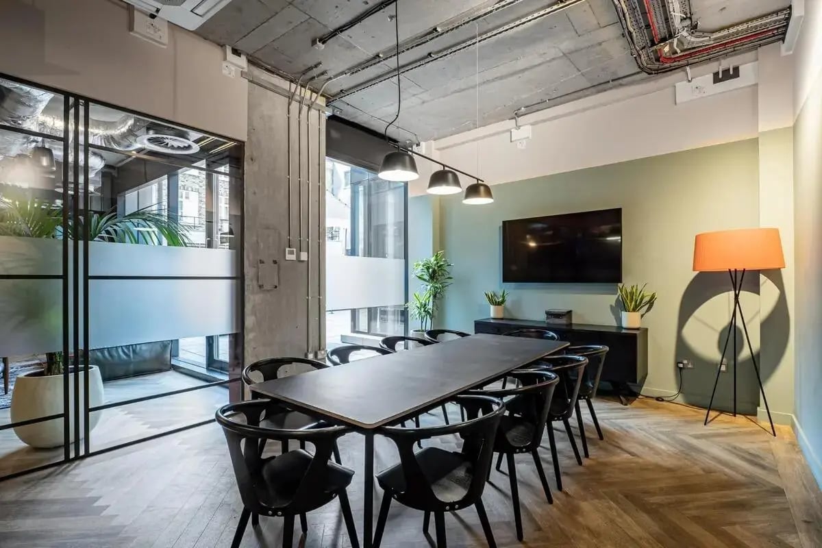 Modern meeting room with black table and chairs at Chapter Spitalfields in London Student Accommodation