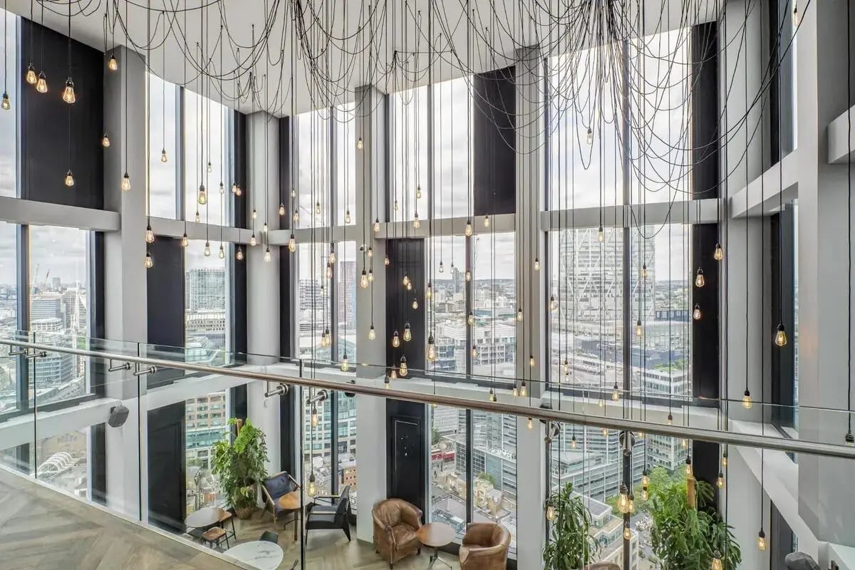 Chandelier lighting and city views lounge area at Chapter Spitalfields in London Student Accommodation