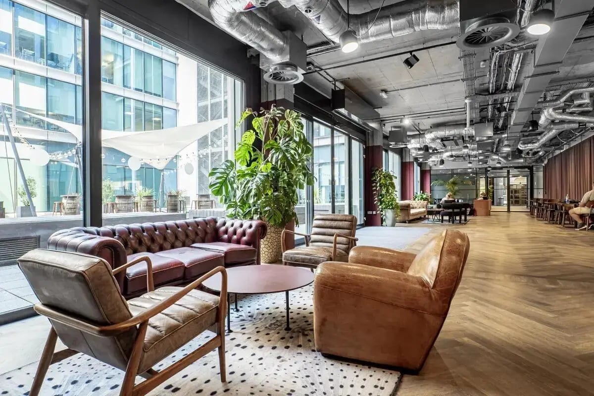 Leather sofas armchairs coffee table lounge area at Chapter Spitalfields in London Student Accommodation