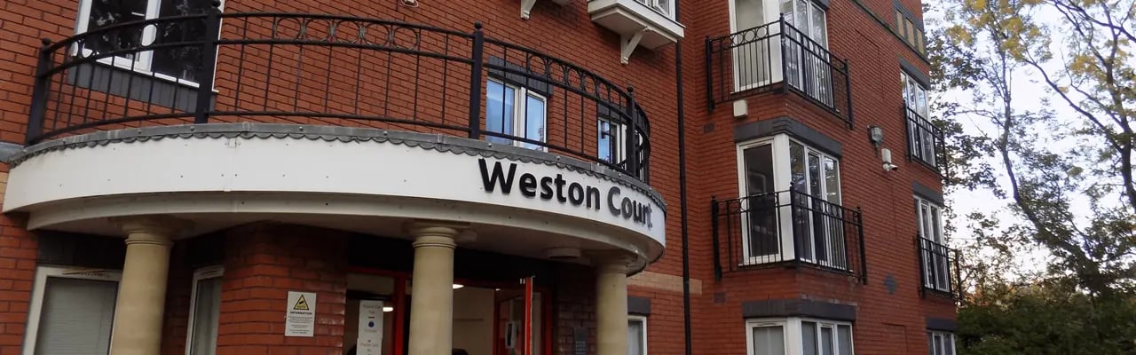 Weston Court building entrance with columns and balconies exterior at Weston Court in Manchester Student Accommodation