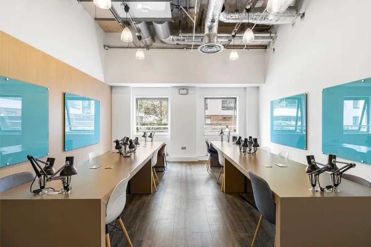 Long tables with lamps and chairs coworking space at Chapter Islington in London Student Accommodation