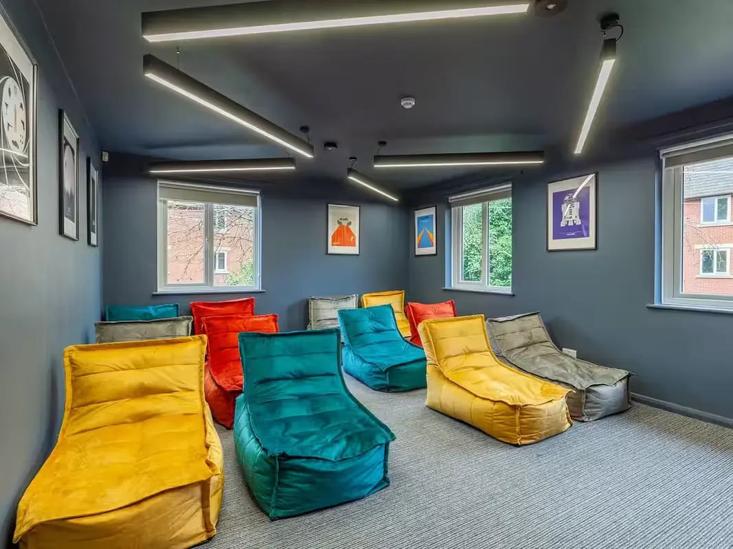 Colorful bean bags on carpeted floor communal area at Calthorpe Court in Birmingham Student Accommodation