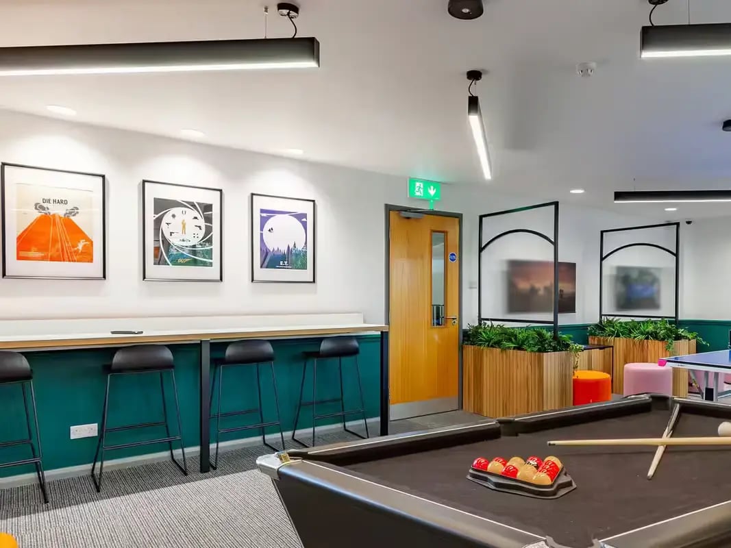 Pool table bar stools artwork and plants common area at Calthorpe Court in Birmingham Student Accommodation
