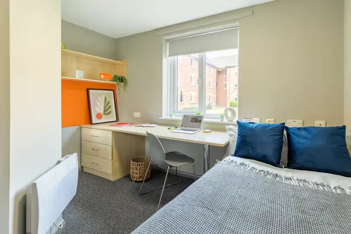 Desk bed pillows artwork and heater bedroom at Calthorpe Court in Birmingham Student Accommodation