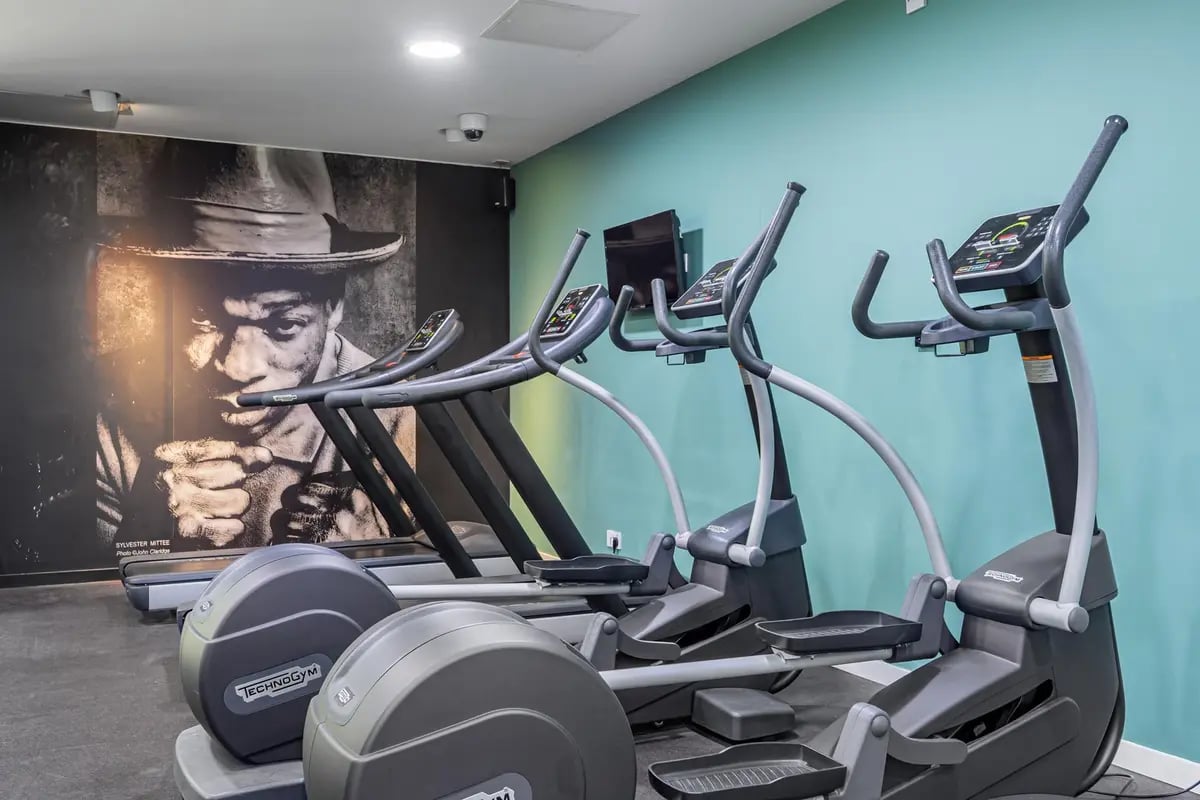 Treadmills and elliptical machines in gym area at Chapter Old Street in London Student Accommodation