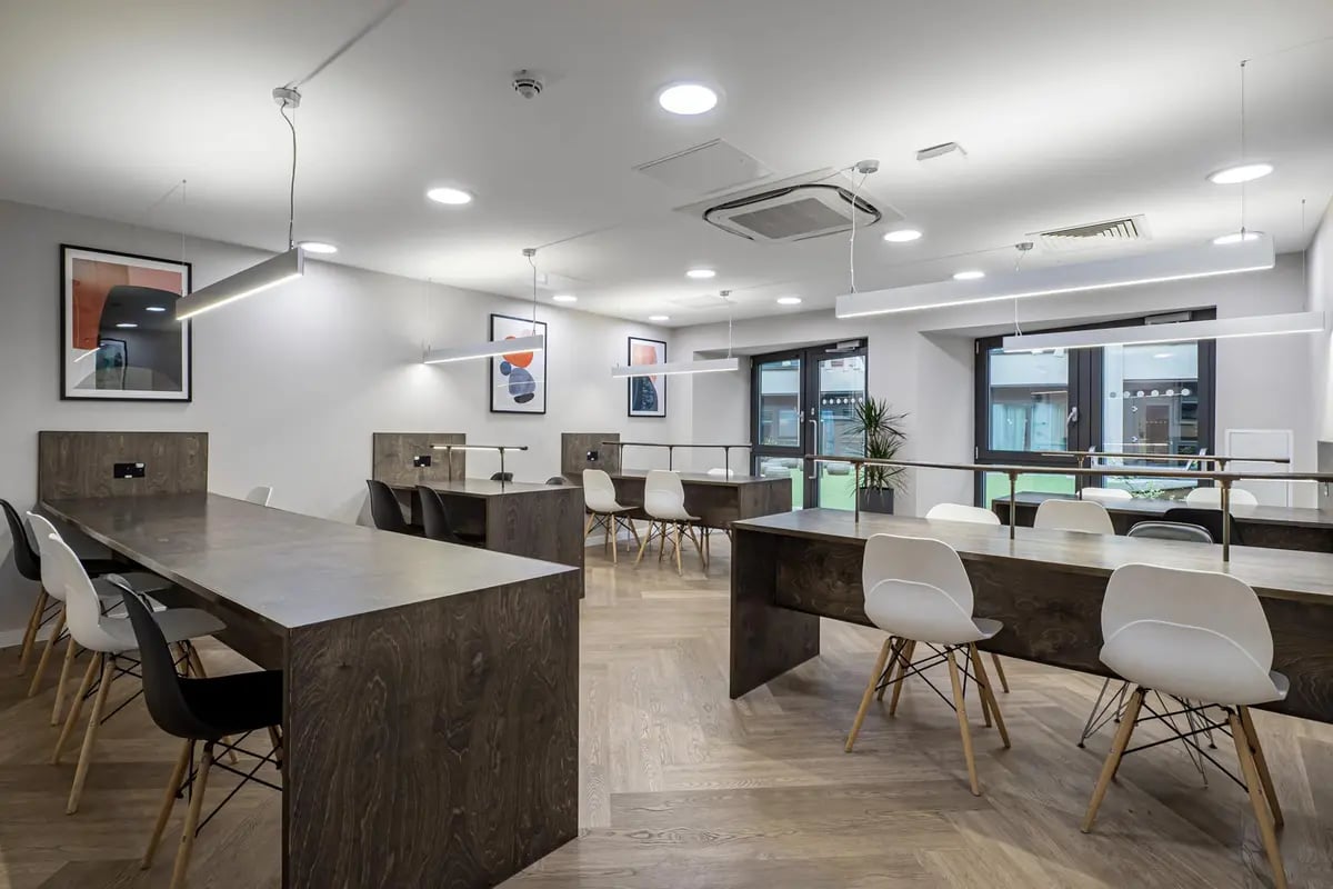 Long tables white chairs artwork study area at Chapter Old Street in London Student Accommodation