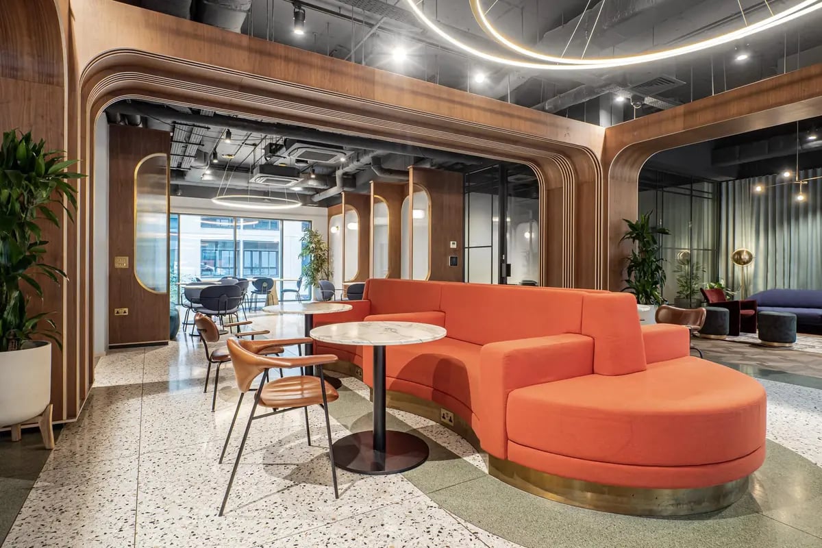 Orange sectional sofa marble tables seating area lounge at Chapter Old Street in London Student Accommodation